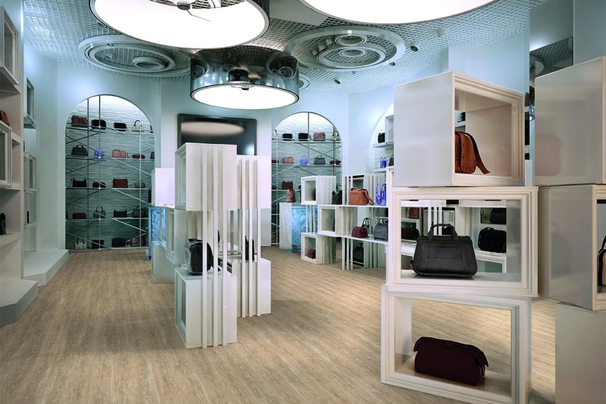 Luxury store interior design art deco style with hints of Contemporary. Interior white store with lots of shelves. Shop for the sale of bags on the shelves of handbags. 3D render.